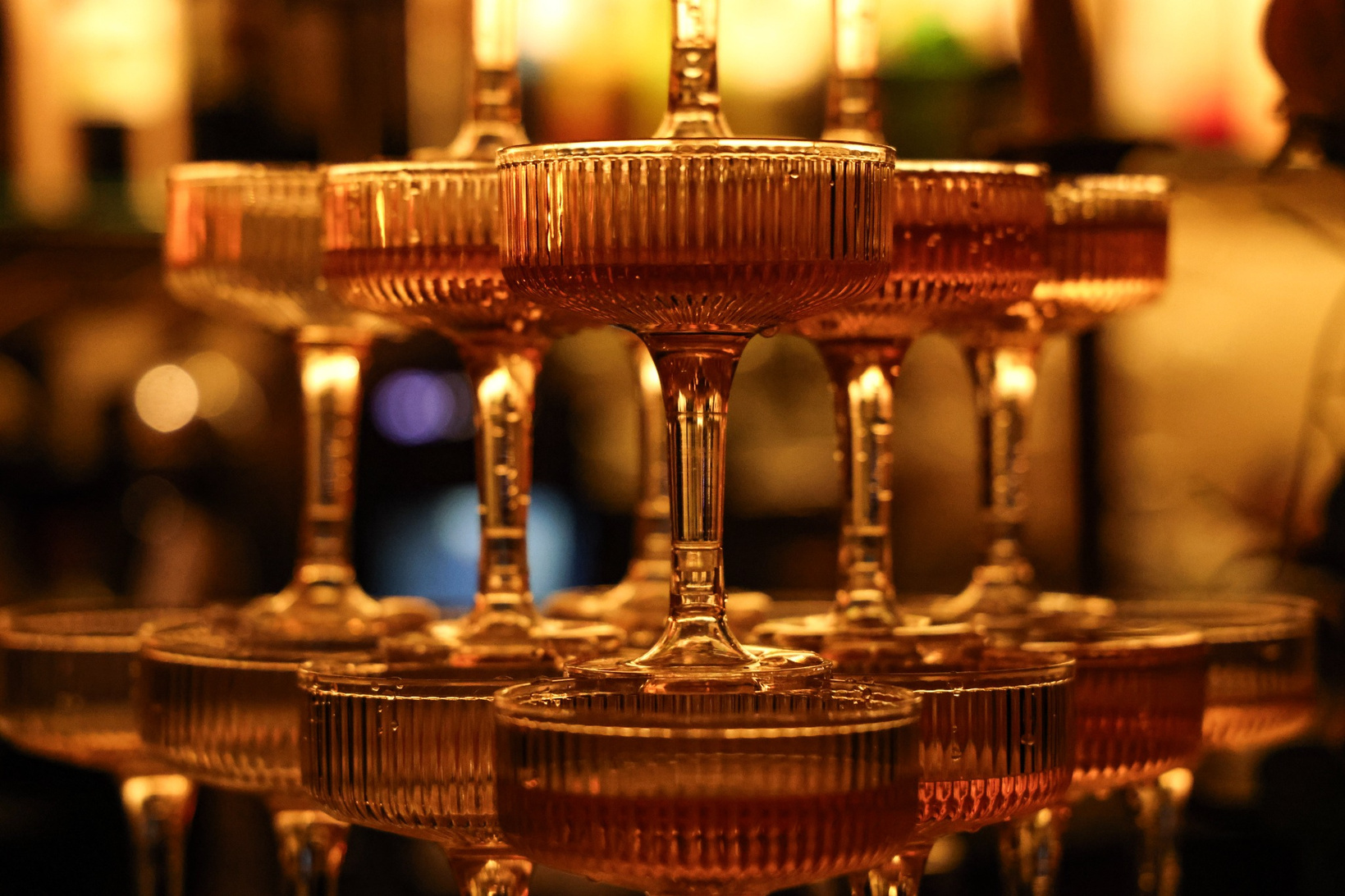 Golden glassware stacked for welcome rosé service